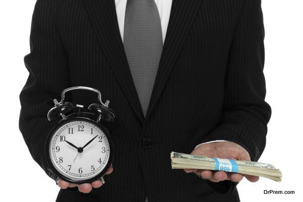 Close up of businessman holding a clock and one stack of cash in