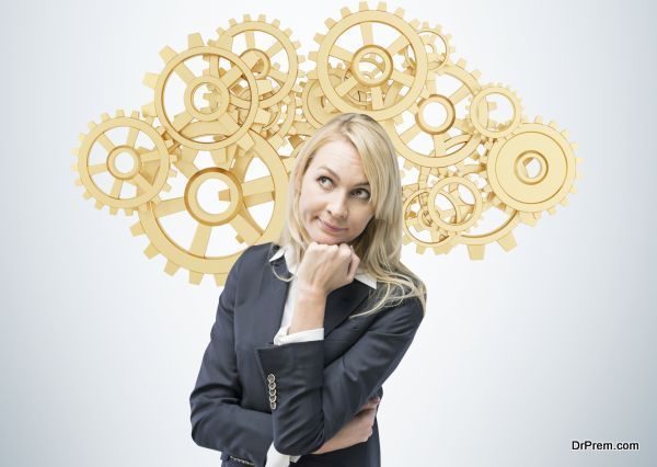 Beautiful blonde business woman is thinking about optimisation of the business process. A concept of business management solutions. Golden gears as a cloud.